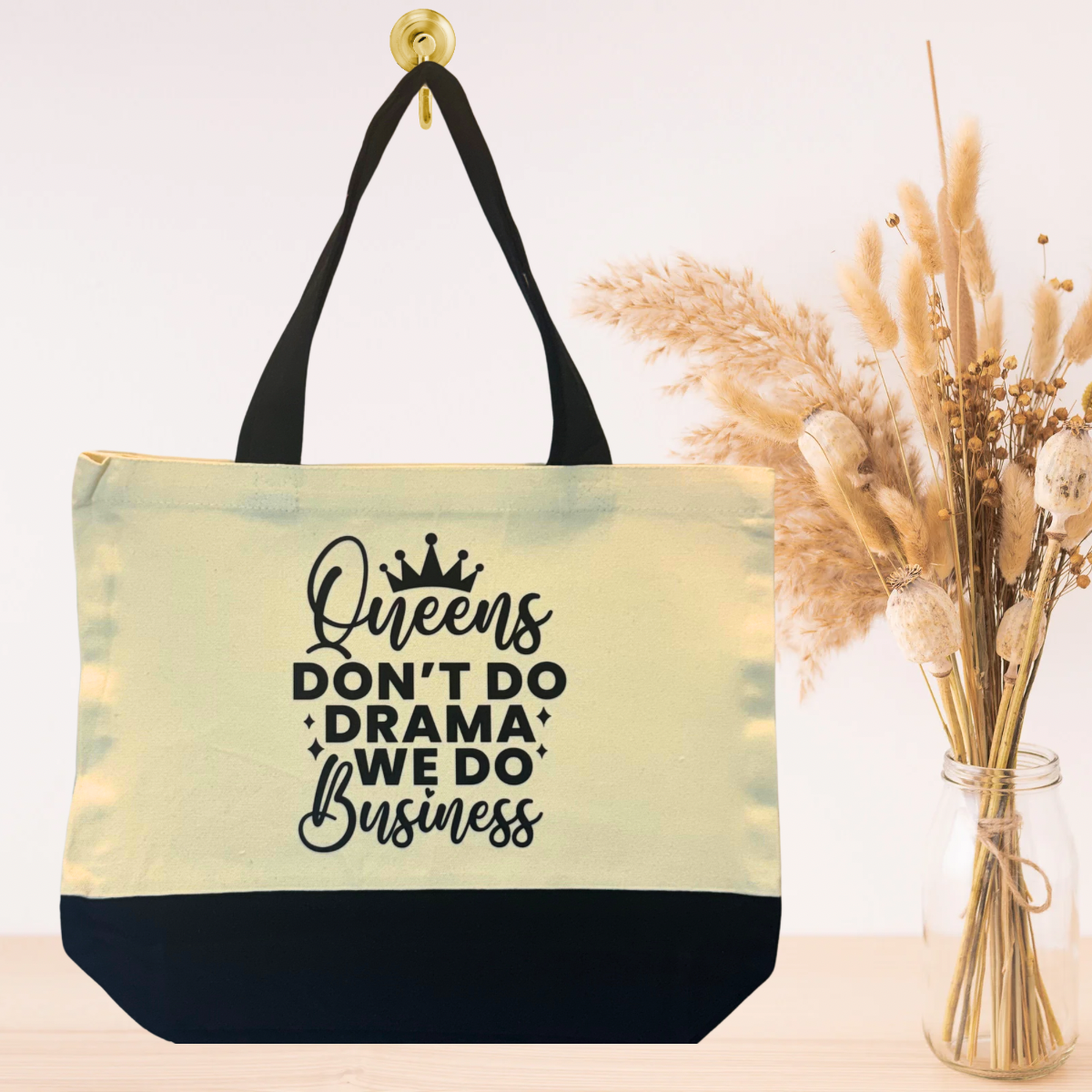 Black canvas tote bag with bold inspirational quote design